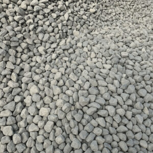 Close-up view of a large pile of crushed gray gravel stones used for landscaping or construction