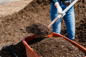 brown soil in orange plastic bucket