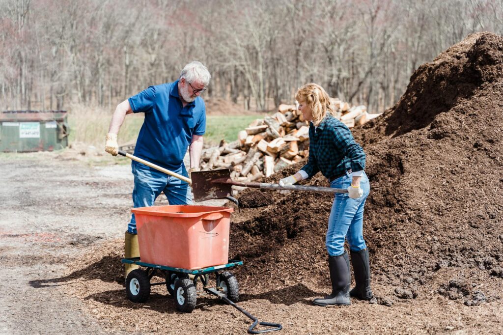 elderly couple shoveling the soil